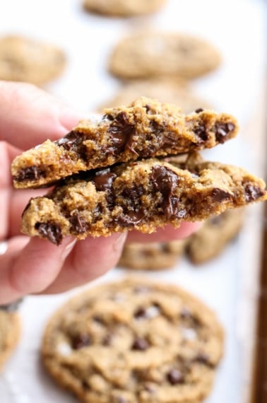 hand holding an almond flour cookie split in half.