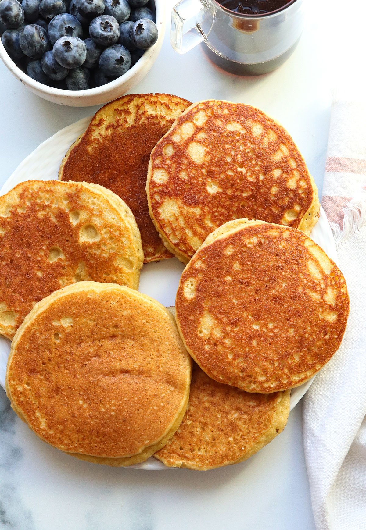 almond flour pancakes arranged on a white plate.