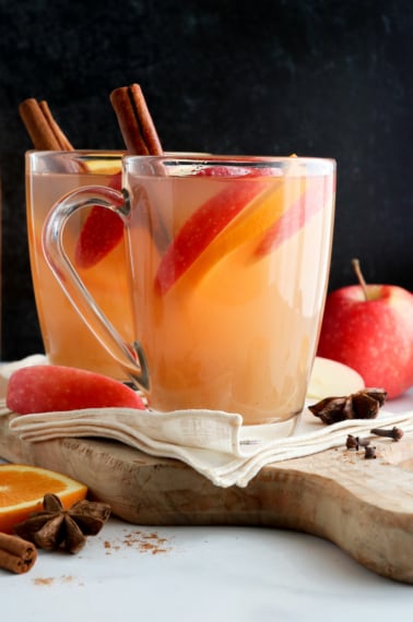 apple cider mugs in front of black surface