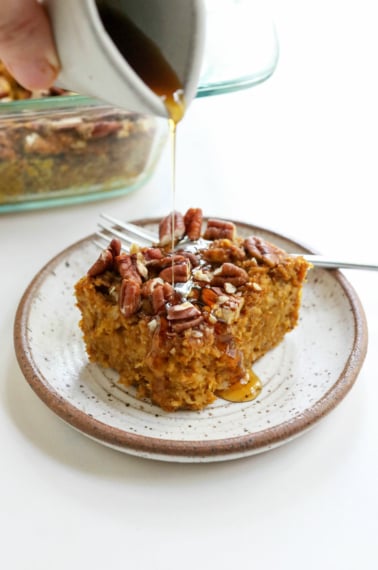 slice of pumpkin baked oatmeal with maple syrup