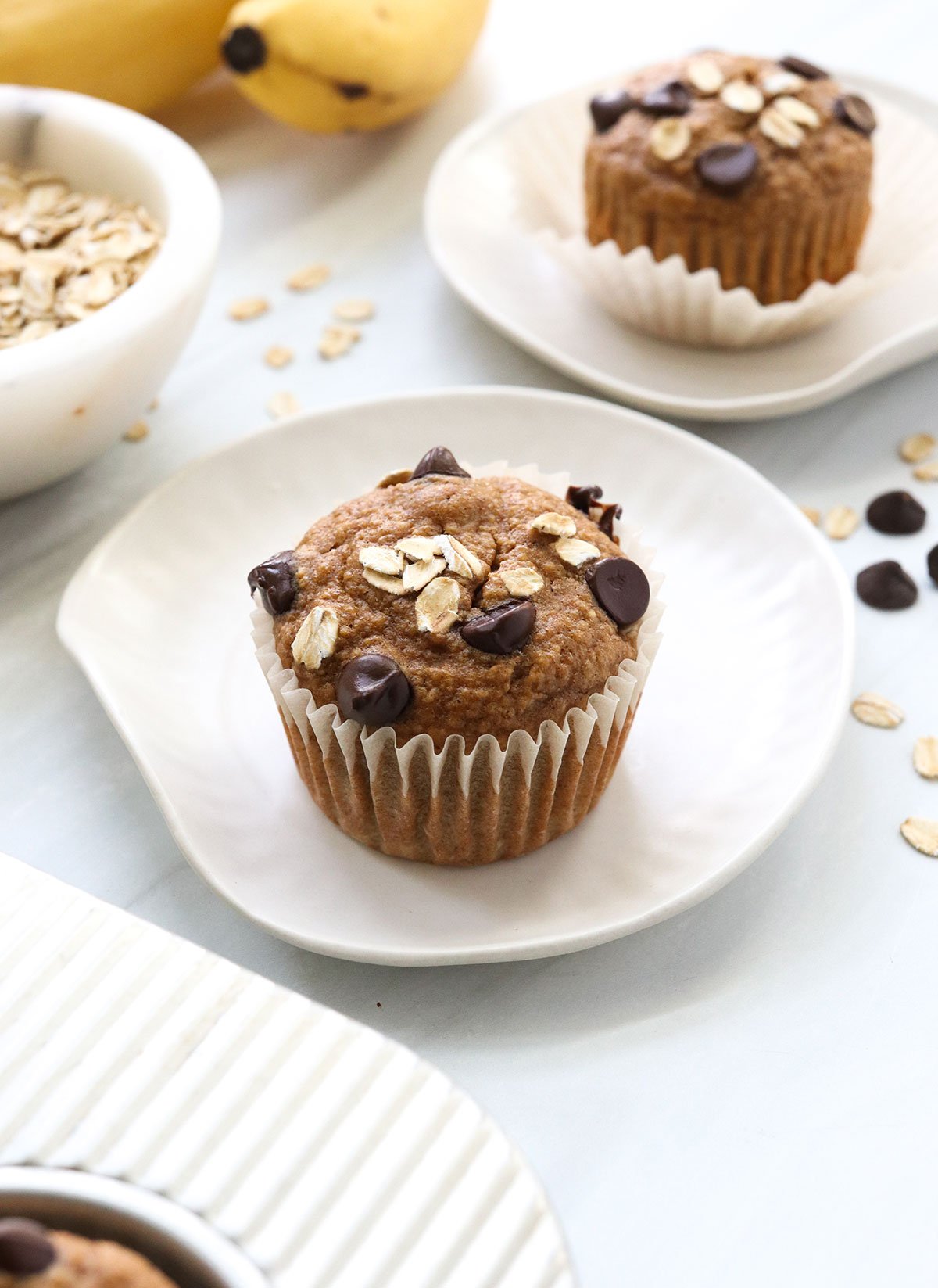 banana oatmeal muffins on white plates.