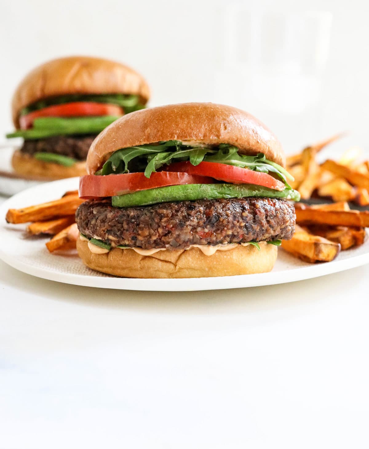 veggie burgers on white plates