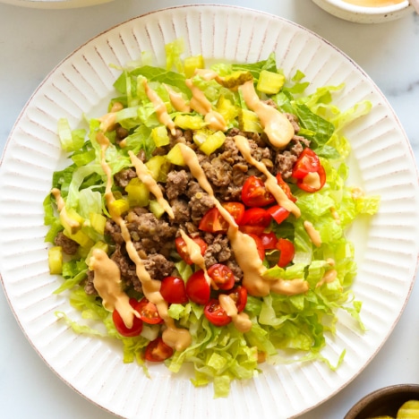 big mac salad served on a large white plate.