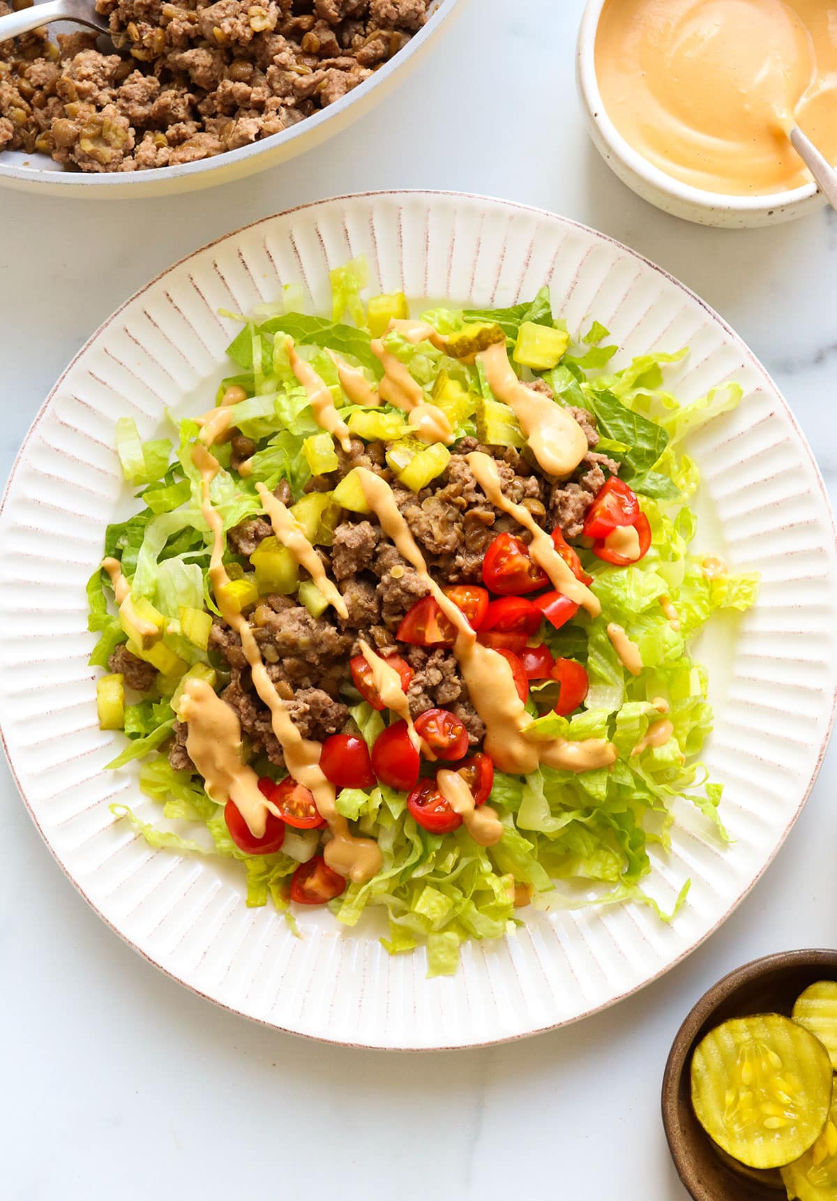 big mac salad served on a large white plate.