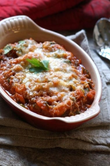 Baked vegetable marinara in red casserole dish