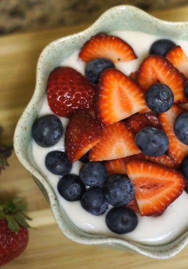 Coconut cream pudding topped with berries