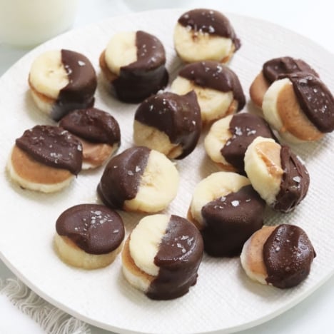 frozen banana bites on white plate.