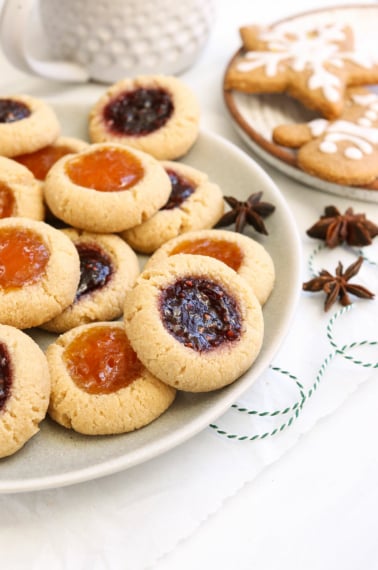 Almond flour thumbprint cookies on a plate.