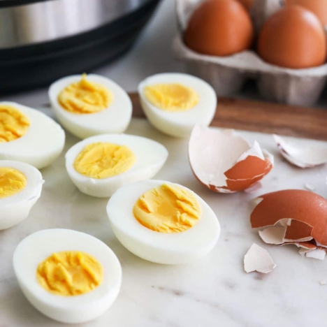 hard boiled eggs cut open with the peeled shell nearby