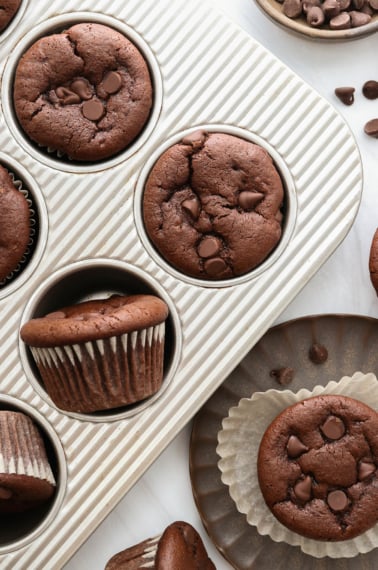 chocolate muffins in pan and on a plate.