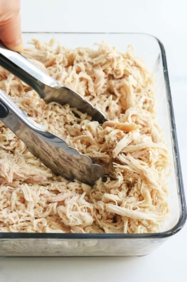 shredded chicken with tongs