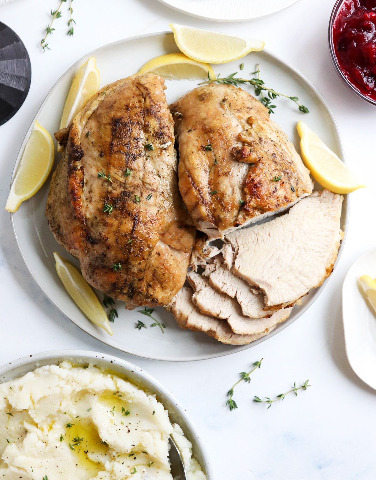 Cooked turkey breast on a white platter