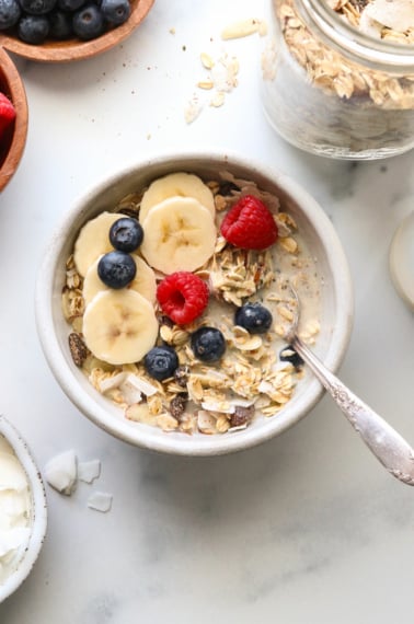 muesli served with milk and a spoon.