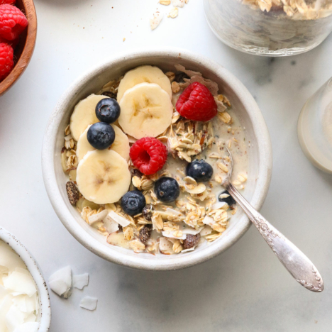 muesli served with milk and a spoon.