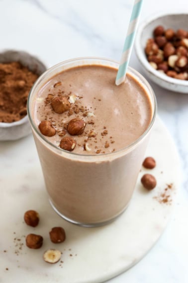 chocolate hazelnut smoothie in glass with straw