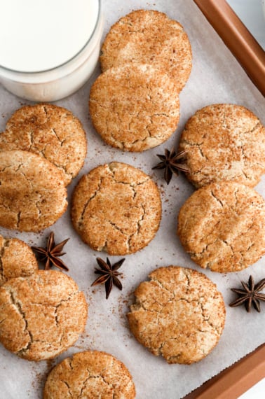 almond flour snickerdoodle cookies on baking sheet with milk