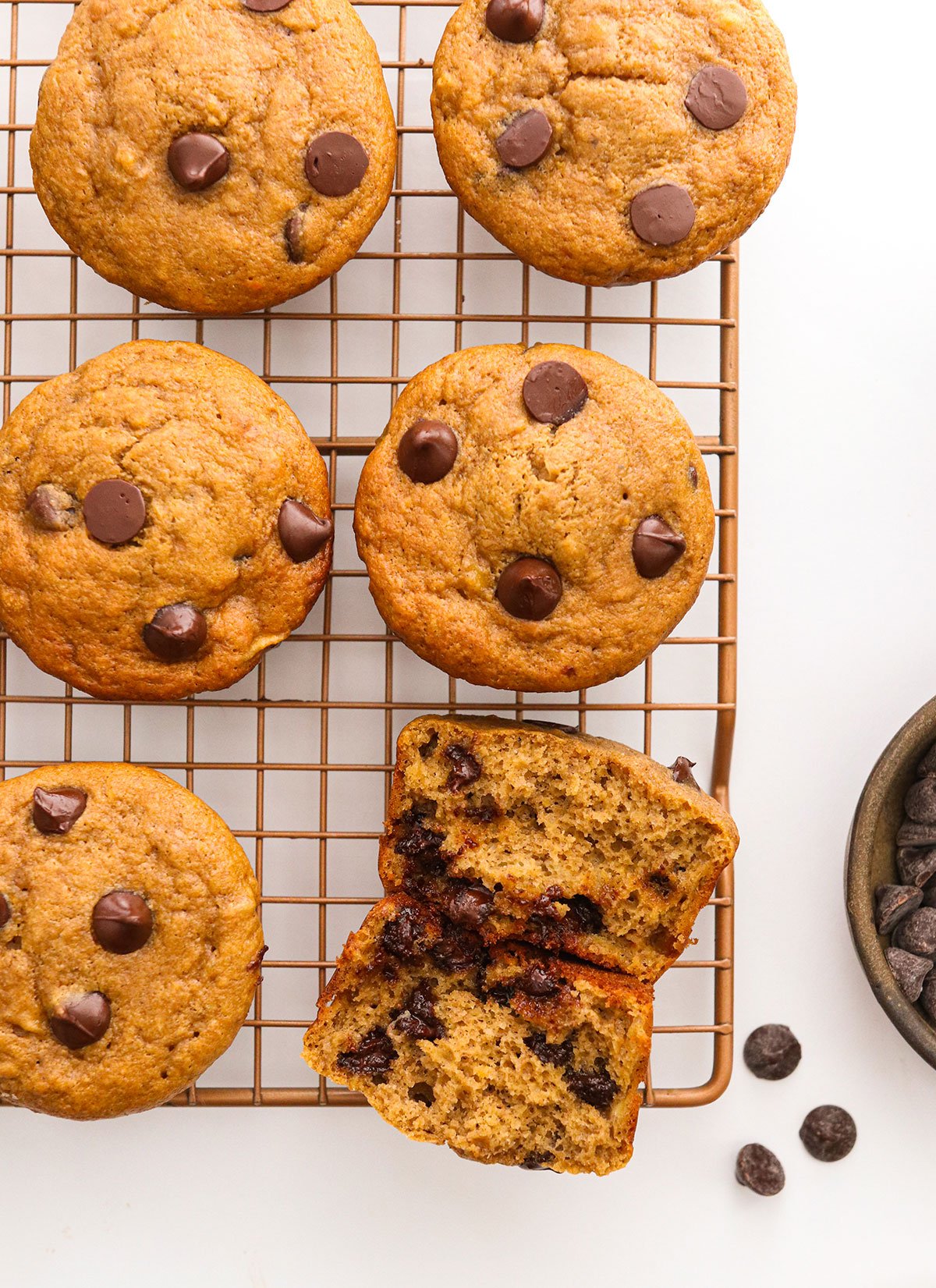 protein muffins on cooling rack with one split in half.