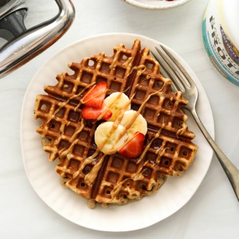 protein waffle topped with fruit and peanut butter.