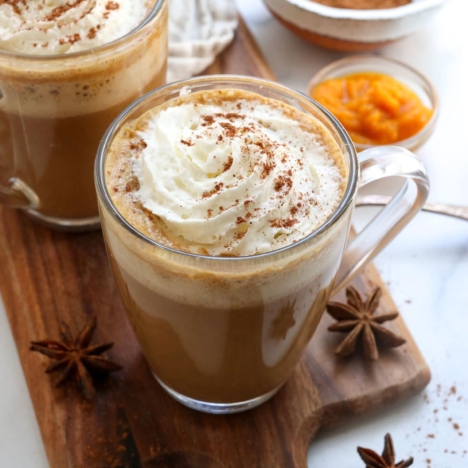 pumpkin spice latte in glass with whipped cream on top