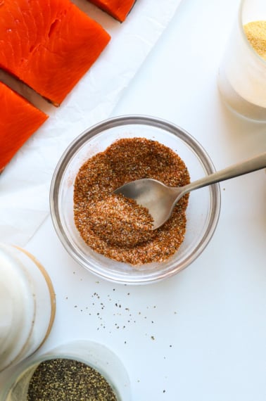 salmon seasoning stirred in a glass bowl.