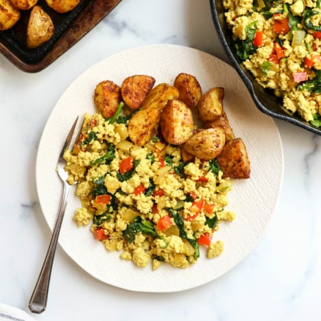 tofu scramble on plate with roasted potatoes