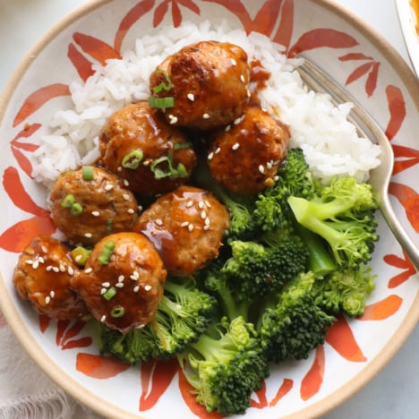 baked turkey meatballs served with broccoli and rice.