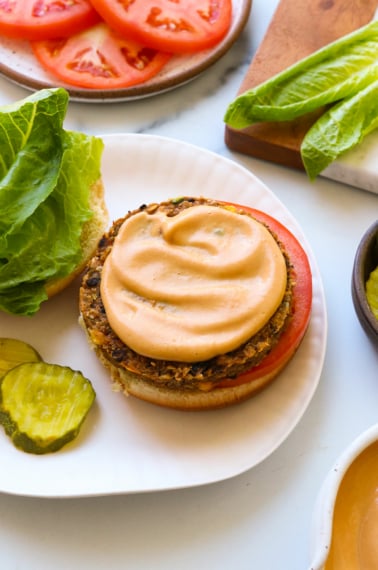 vegan burger sauce spread on a veggie patty and bun.