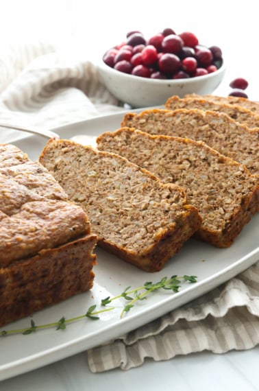 Vegetarian meatloaf sliced on a serving plate.